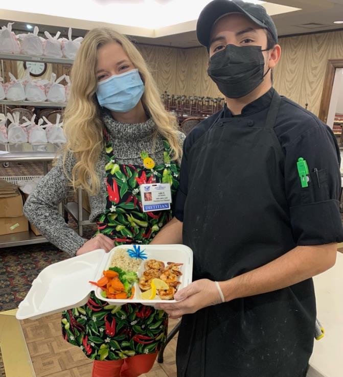 employees holding plate of food