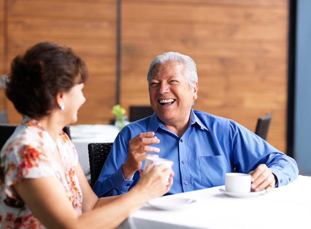 couple laughing at table