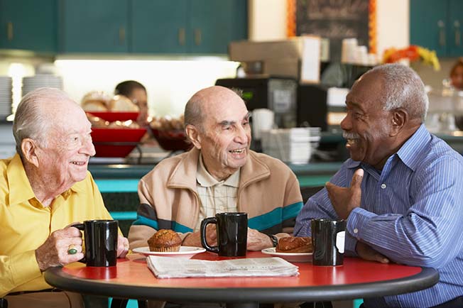 men having breakfast and talking